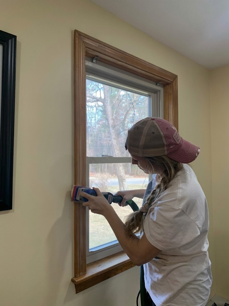 Roll With It painter carefully preparing window trim